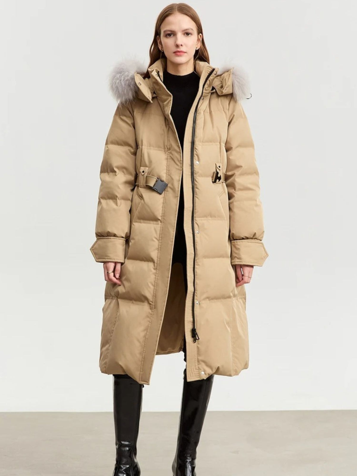 Angled front view of camel puffer coat with fur-trimmed hood