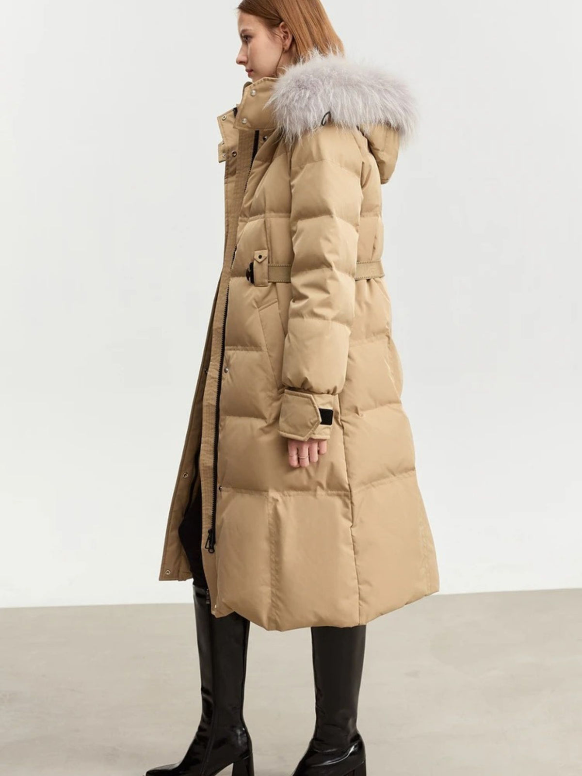 Side view of camel puffer coat with belted waist and fur hood