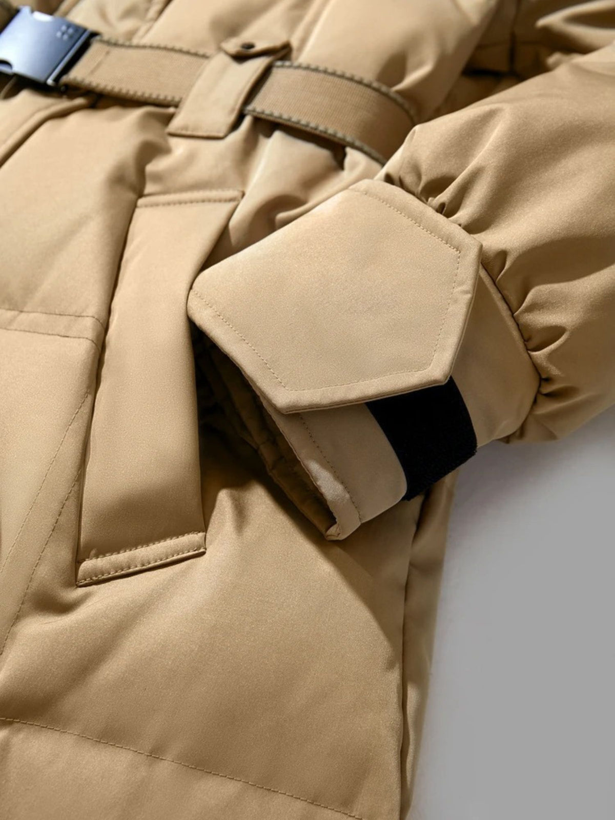 Close-up of camel coat showing front pocket and sleeve detail
