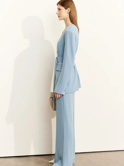 Angled front view of belted light blue blazer paired with matching trousers