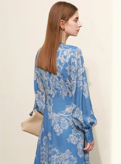 Back view of blue floral midi dress with long sleeves and zip closure