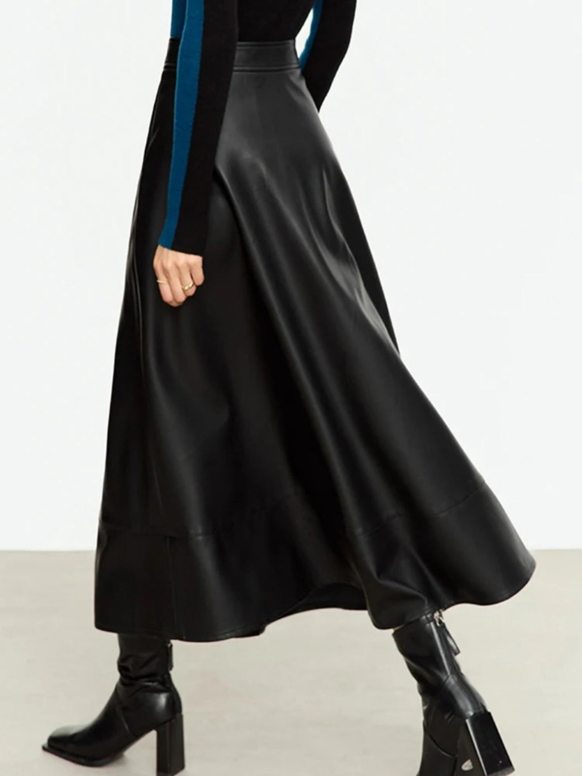 Angled front view of black satin skirt with smooth finish and high waist
