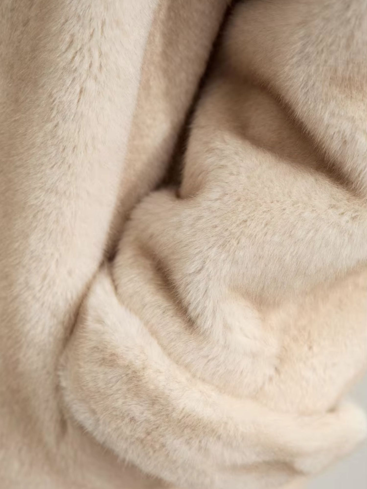 Close up of a camel fur coat.