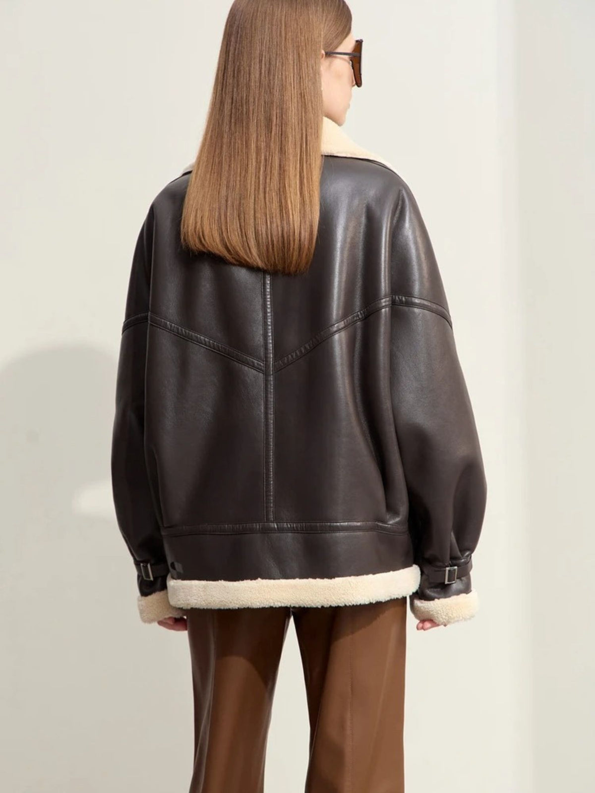 Back view of faux leather shearling jacket with contrast hem detail