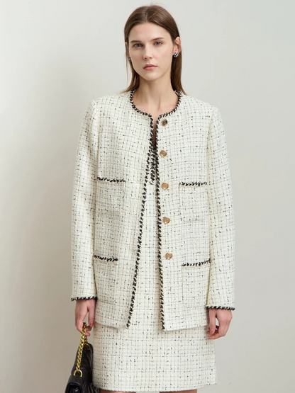 Side profile of ivory tweed jacket with long sleeves and textured weave