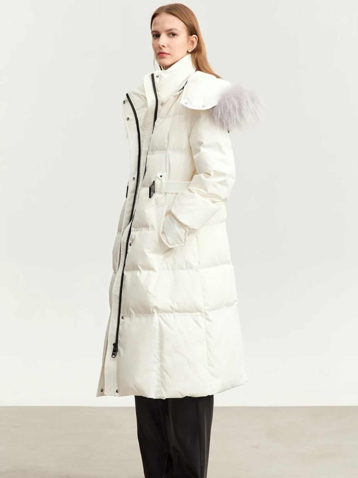 Angled front view of belted white coat with high collar and fur hood