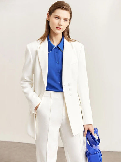 Side profile of white pantsuit with blazer and pleated wide-leg trousers