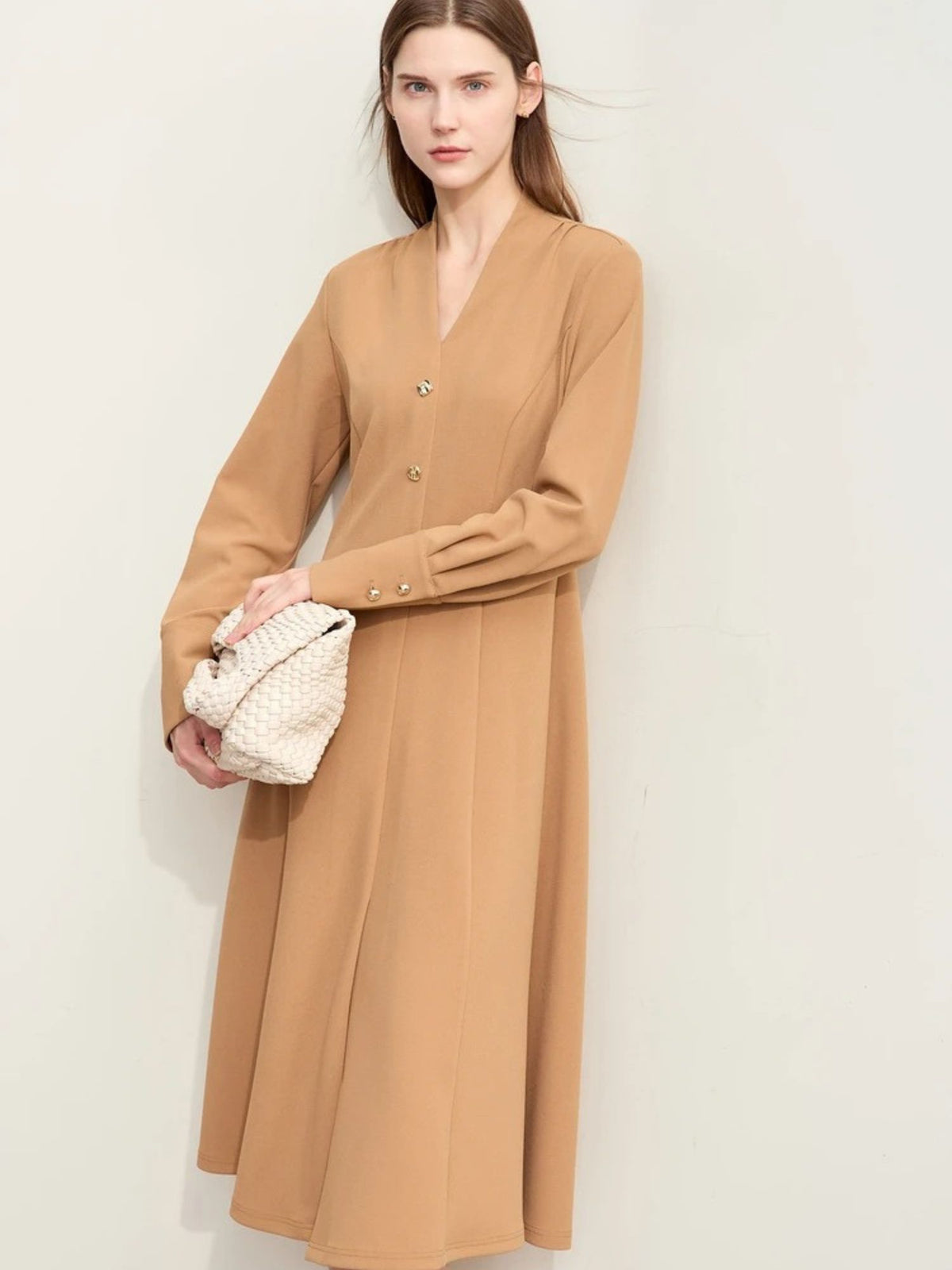 Front angle of camel midi dress with long cuffed sleeves and subtle waist shape